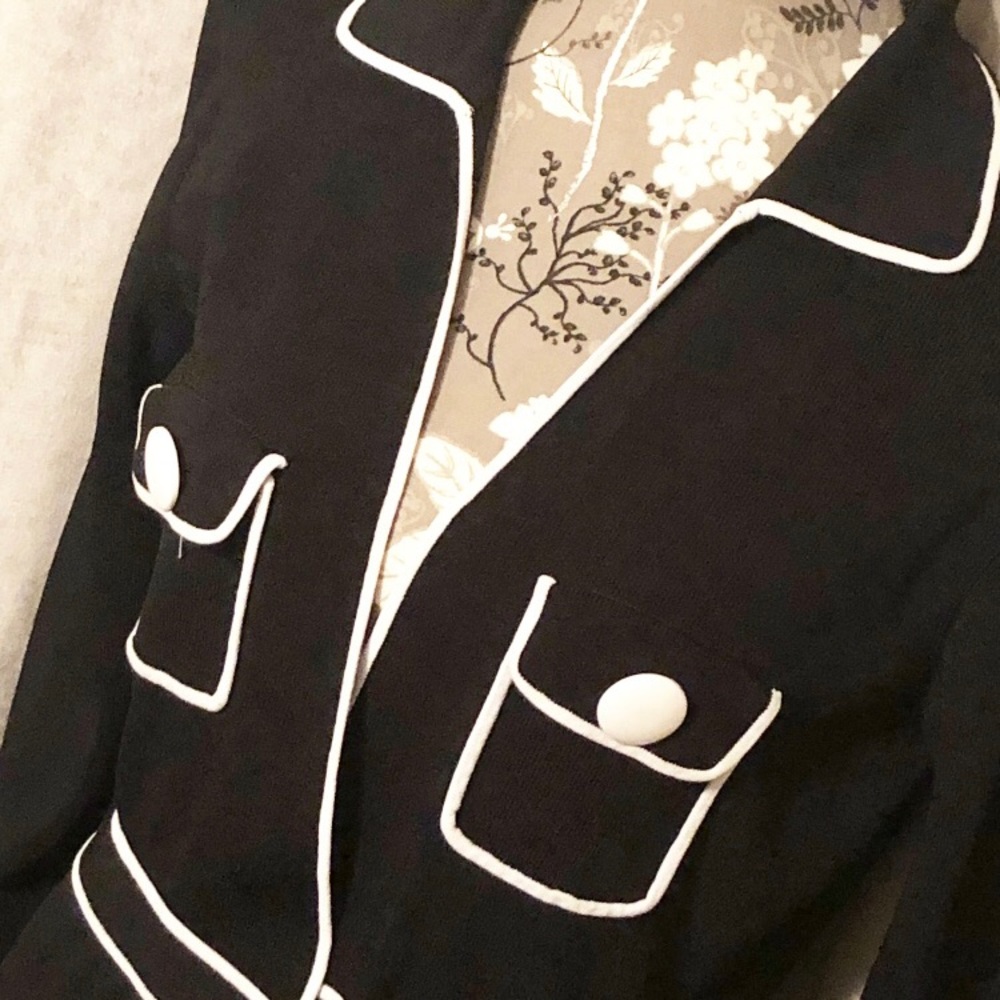 White trimmed, black cardigan.